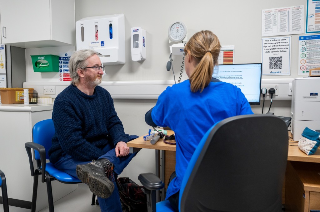 Female Doctor and male patient in community care centre