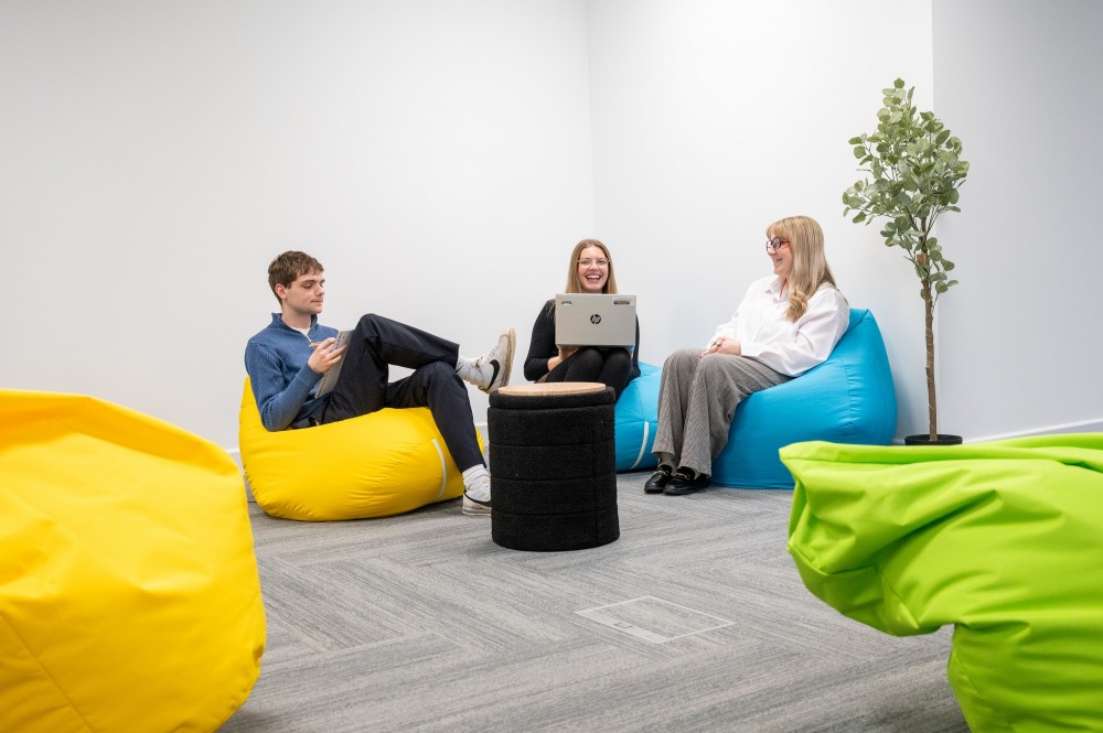 Group of three individuals sat on beanbags