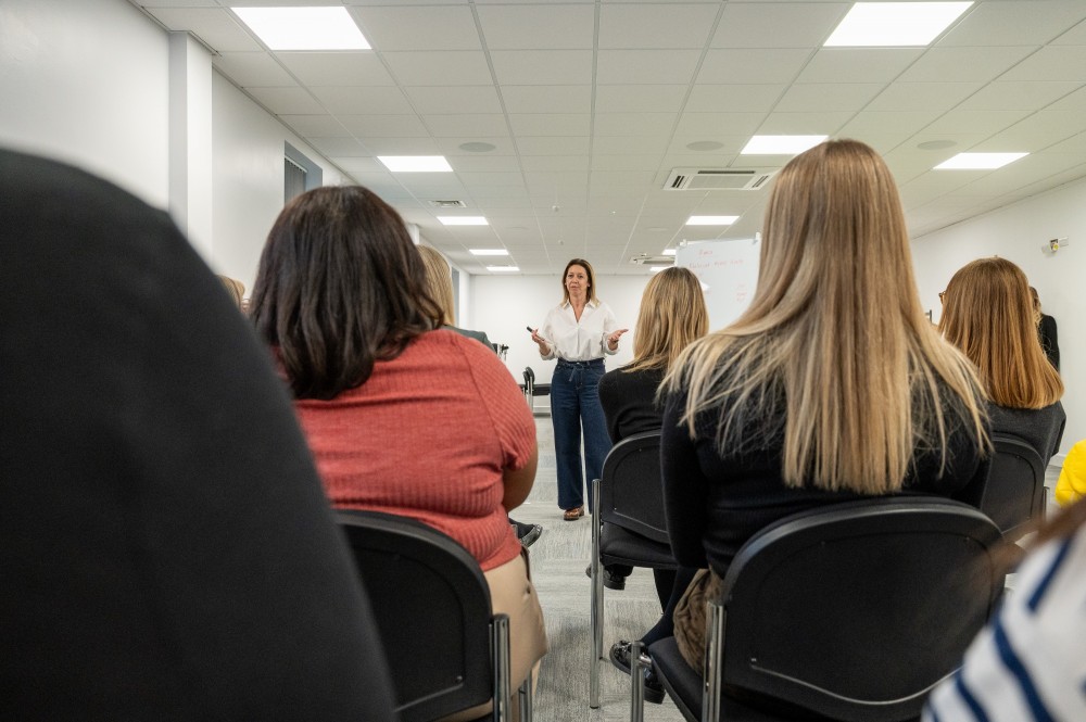 Group of staff sat in rows attending a meeting