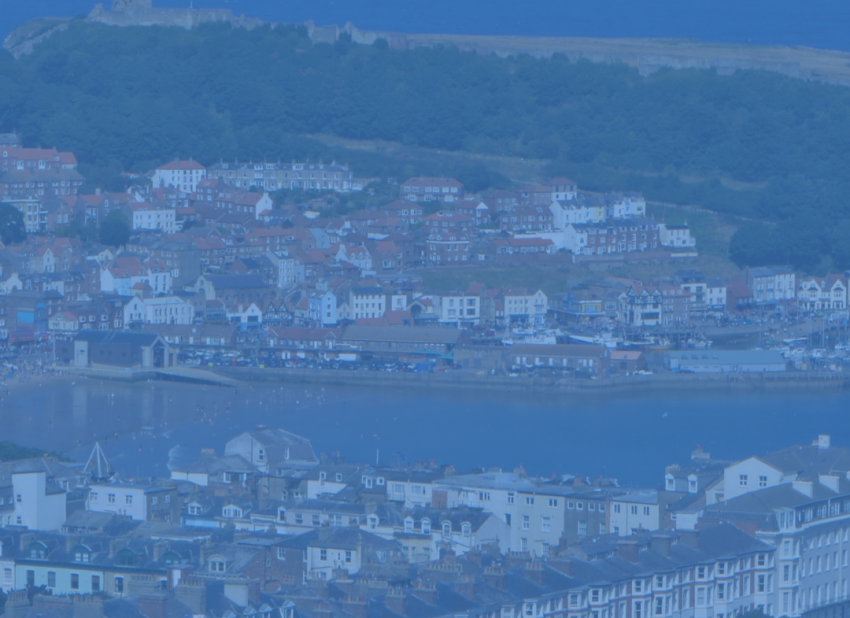Photo of Scarborough castle, town and sea.
