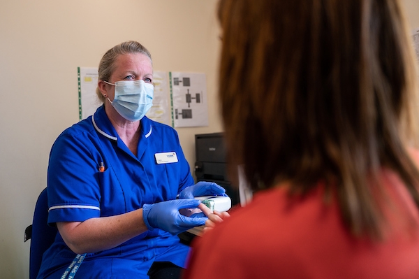 Women having a blood test by a nurse